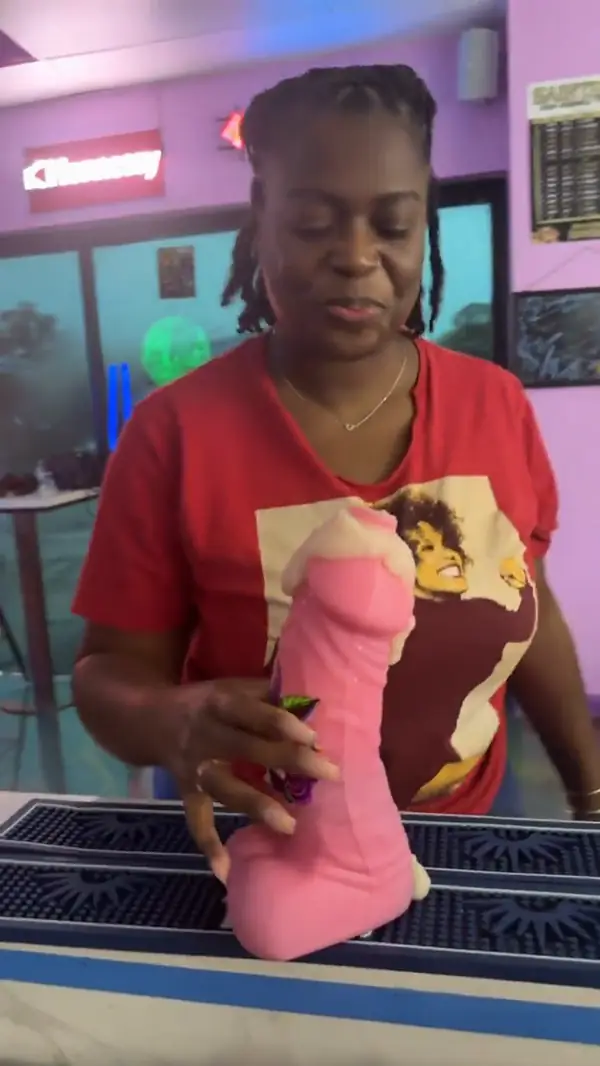 Guest having fun with a novelty party cup at the bar